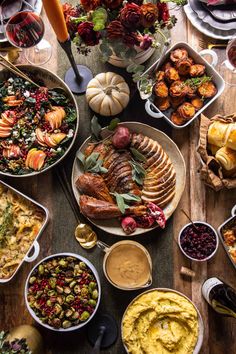 a table filled with lots of different types of food and dishes on top of it