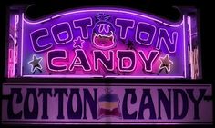 the cotton candy sign is lit up in purple and red colors with stars on it