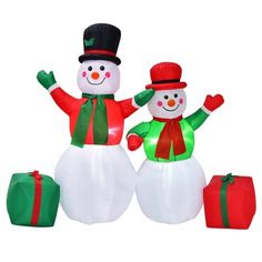 two inflatable snowmen standing next to each other