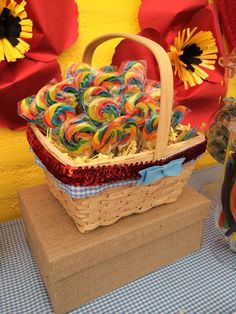 a basket filled with lollipops sitting on top of a table