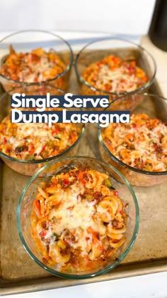 four glass dishes filled with pasta and sauce on top of a baking sheet, text reads single serve dump lasagna