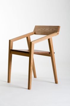 a wooden chair sitting on top of a white floor