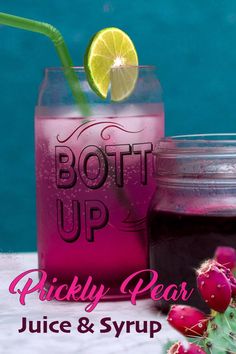 a pink drink in a mason jar with a lime slice on top and the words, bott up prickly pear juice & syrup