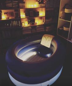 an inflatable chair sitting on top of a wooden floor next to bookshelves