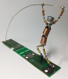 an electronic device is connected to a circuit board with wires and magnets on it