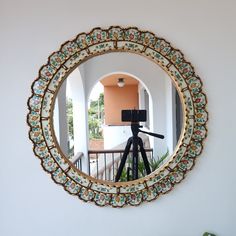 a camera is set up in front of a mirror to take a photo on the balcony