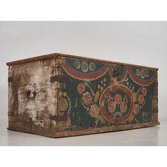 an old wooden box with designs painted on it