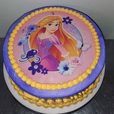 there is a cake decorated with the image of rappo from tangled hair and flowers