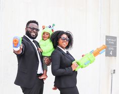 Black Family Halloween Costumes For 4, Family Halloween Costumes Black Family, Family Costume With Newborn, Black Family Costumes, Men In Black Family Costume, Family With Baby Halloween Costumes, Alien Family Halloween Costume, Wakanda Family Costumes, Family Wrestler Costumes