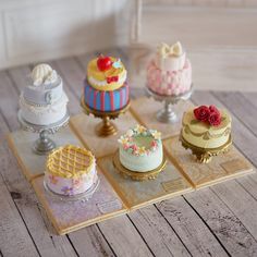 there are many different cakes on the trays that have been placed on top of each other