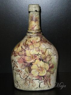 a vase with flowers painted on it sitting on a table