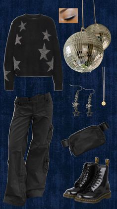 an assortment of clothes and accessories are arranged on a dark blue background, including black boots