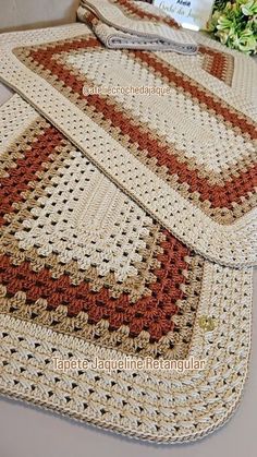 three crocheted placemats sitting on top of a table