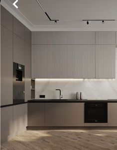 a modern kitchen with marble counter tops and stainless steel appliances, along with wood flooring