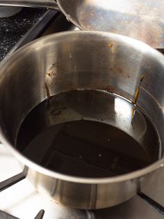 two pans sitting on top of a stove next to each other in the same bowl