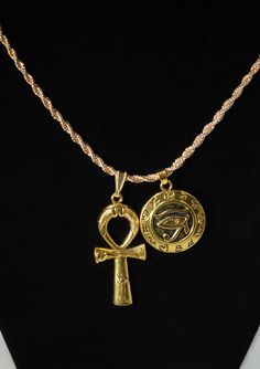 "Eye Of Horus Shield &  Large Ankh Charm Duo Necklace  ☆   Round Eye of Horus Shield Charm       is lightweight and        hollow on the back.  ☆ Charms are Made of zinc alloy with       18 Karat gold plating   ☆ Includes {1} 2mm gold ROPE chain       of YOUR CHOICE length       long with lobster clasp.       CHOOSE YOUR ROPE CHAIN LENGTH  from our pull-down menu above: ---     2mm wide by 45 cm/ 17.7 inches long      OR ---     2mm wide by 50 cm 20 inches long     OR ---     2mm wide by 55 cm 21.6 inches long     OR ---     2mm wide by 60 cm 23.6 inches long ☆ Artisan Crafted African Charm Necklace       For Her | For Him | Unisex Jewelry ☆ The Eye of Horus is an       ancient Egyptian symbol       of protection, royal power,       and good health.  ☆ The Ankh is a powerful       symbol o Eye Of Horus Jewelry, Ankh And Eye Of Horus, Duo Necklace, Eye Of Horus Necklace, Egypt Jewelry, Ankh Necklace, Necklace Mens, Egyptian Symbols, Egyptian Jewelry