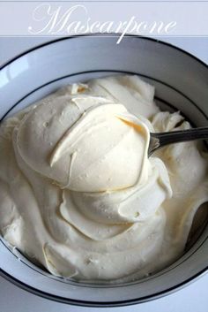 a bowl filled with whipped cream on top of a table