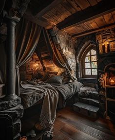 a bed in a room with stone walls and wooden flooring is lit by candles