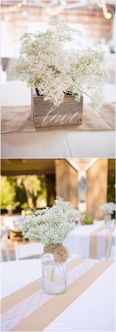 white flowers in a vase on top of a table with other tables and chairs behind it