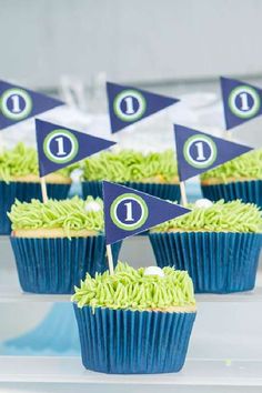 cupcakes with green frosting and blue flags