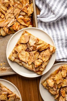 apple crisp bars on plates next to a baking pan