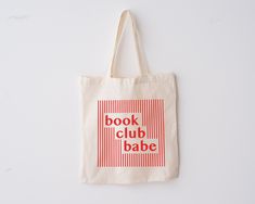 a book club babe tote bag hanging on a wall