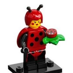 a lego ladybug holding a green leaf and red flower in it's hand