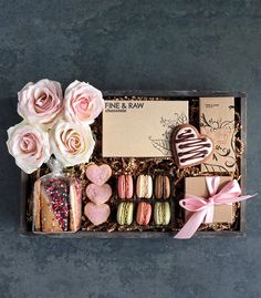 a box filled with lots of different types of cookies and pastries on top of a table