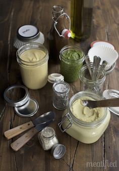 some jars and spoons on a wooden table