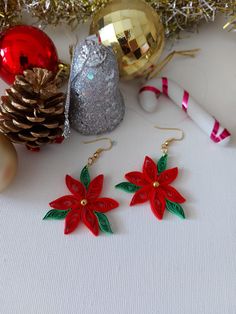 The design of these earrings is inspired by poinsettia. It is made using red and green paper. Quilling earring poinsettia are attached to steel earring hooks. Poinsettia earrings are sent in gift wrapping. Christmas accessories are easy to wear and are very lightweight. The paper from which the earrings are made is environmentally friendly and does not contain acids. Its colors do not fade or stick to your skin. Earrings are made to order. Since each product is a work of art, there may be slight differences. However, the earring will look like the image in the photo. Dimensions: Hook length: 2 cm Length (without hooks): 4 cm Max Width: 4 cm Please message me if you want a different size or a different color. It is suitable for daily use, but don't go in the shower or in the sea with your e Quilled Christmas Earrings, Quilling Jewelry Ideas, Quilling Studs, Quilling Snowflakes, Poinsettia Earrings, Quilled Christmas, Quilling Flower Designs, Christmas Quilling, Paper Quilling Earrings