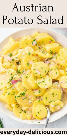 a white bowl filled with potato salad on top of a table