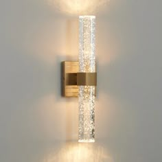 a wall light that is on the side of a wall with some lights in it