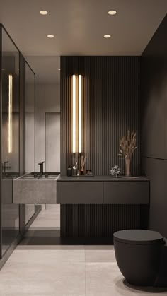 a modern bathroom with two sinks and large mirrors on the wall, along with black cabinets