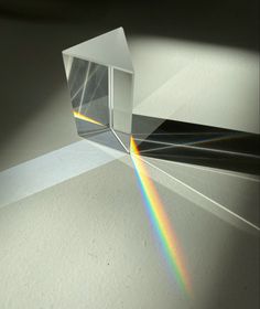 an image of a rainbow being reflected in a glass block with light coming through it