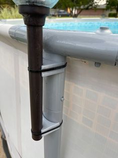 an outside view of a swimming pool with water in the bowl and pipes running through it