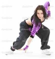 a woman in black and purple is posing for the camera with her hands on her hips