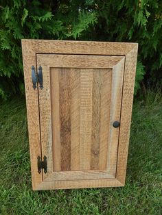 a small wooden cabinet sitting in the grass