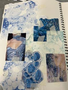 an open notebook with blue and white designs on it, including paper collages