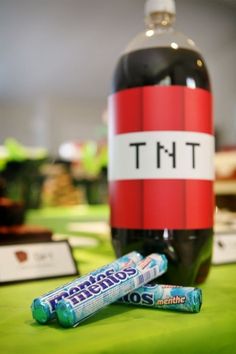 two candy bars sitting on top of a table next to a bottle of tmt