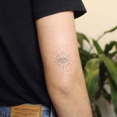 a person with a tattoo on their arm that has an all seeing eye in it