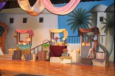 the stage is set for a play with chairs and other items on it's wooden floor