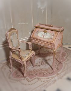 an antique pink desk and chair are sitting on a rug in front of a white wall