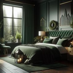 a bedroom with dark green walls and wood flooring is lit by candle lights on the bed