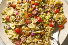 a bowl filled with pasta salad and a fork