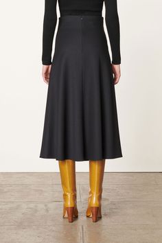 The mid-length black Boushra skirt is a wardrobe staple. Crafted in viscose-blend jersey, it offers a soft feel and elegant fall. Its trapeze cut and ruffles from the waist add movement and dimension to this minimalist piece. Wear it with a pair of high boots or ankle boots for a chic outfit. WHY WE LOVE IT Born in France to a Danish mother and an Italian father, Vanessa Bruno grew up in the fashion world. At just 25 years old, she launched her own brand and began her career as a fashion designe Derek Rose, Jerome Dreyfuss, Knit Shoes, Elegant Fall, Vanessa Bruno, Birthday Shopping, Architecture Fashion, Blouse Dress, Wardrobe Staples