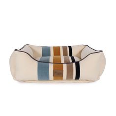 a dog bed that is made out of fabric and has multicolored stripes on it