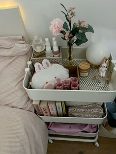 a white tray filled with lots of items on top of a bed next to a night stand