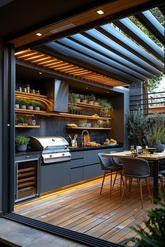 an outdoor kitchen and dining area with wood flooring