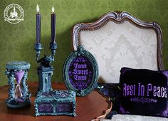 a table topped with purple pillows and decorative items