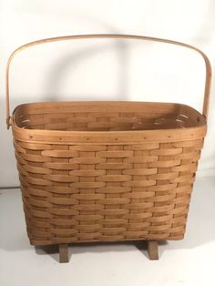 an empty basket sitting on top of a wooden stand